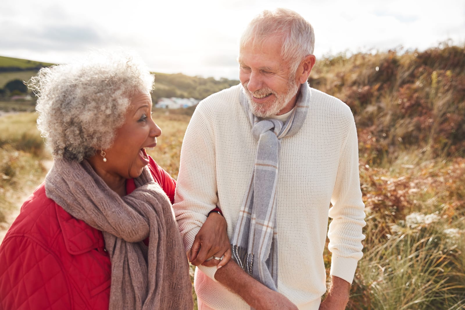 An older couple walking together outdoors