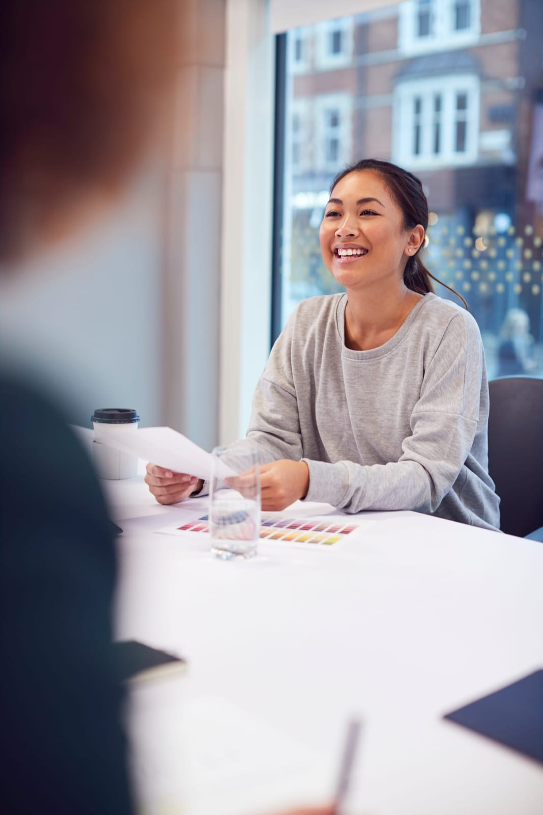 A person reviewing paperwork at a table