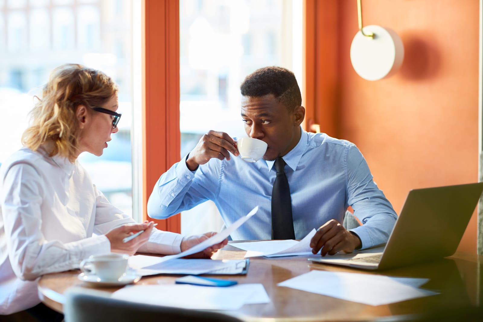 An adviser talking with a client across a meeting table
